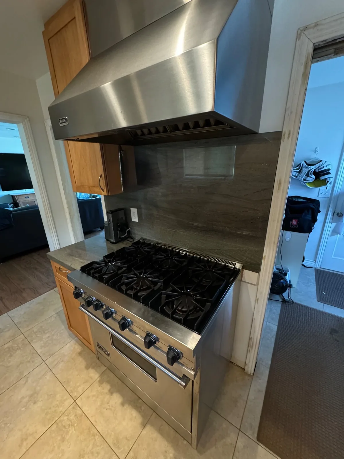 Professional range installed beneath a large hood